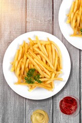 French fries chips with ketchup on desk