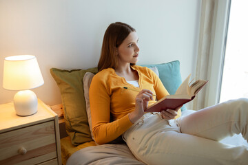 Young Blonde Lady Reading And Learning With Book At Home