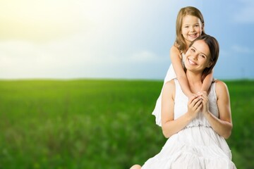 Happy young family hug on nature background