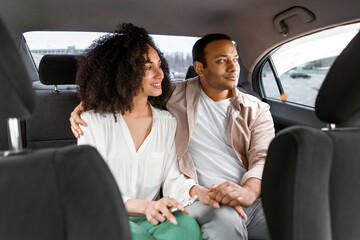 Arab Husband And Wife Sitting On Back Seat In Car
