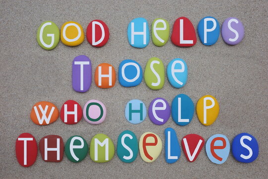 God helps those who help themselves, motivational quote composed with multi colored stone letters over green sand