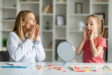 Speech Training For Kids. Professional child specialist woman training with little girl