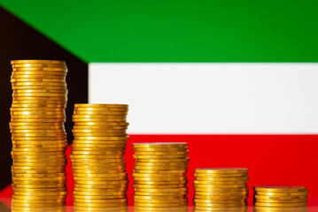 Flag of Kuwait with stacks of golden coins forming downcomming progression. Crisis in economy of...