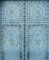 detail of a vintage blue door with metallic decorations