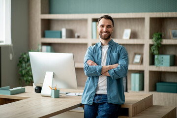 Modern Entrepreneur. Portrait Of Handsome Young Businessman Standing Near Desk At Office