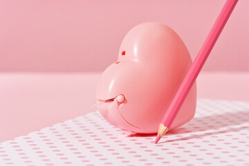 pink pencil tip touching desk on polka dot pink background with diary or copybook. Office or school stationery. Back to school. Drawing writing or storyteling concept. notes taking. meeting