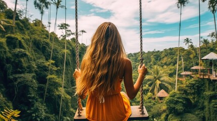 Beautiful girl enjoying freedom on swing in Bali, Indonesia