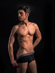 Fototapeta premium Muscular man pulling down underwear to show his butt