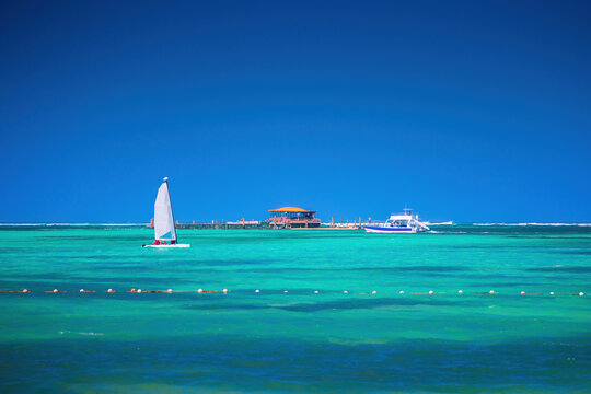 Summer water sports activities in caribbean sea, sailing catamaran sailboat