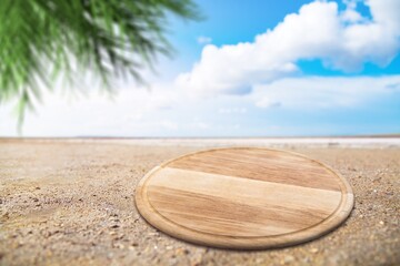 Fototapeta na wymiar Wooden blank pedestal at beach sand.