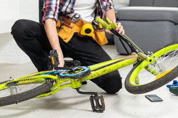 bicycle mechanic adjusting front derailleur mechanism on mountain bike