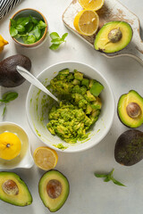 Guacamole in a bowl, cooking homemade avocado mash dip. 