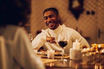 Smiling african american man having a romantic date with his girlfriend at home