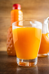 A glass of fruit juice. Orange  juice on wooden table.