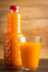 A glass of fruit juice. Orange  juice on wooden table.
