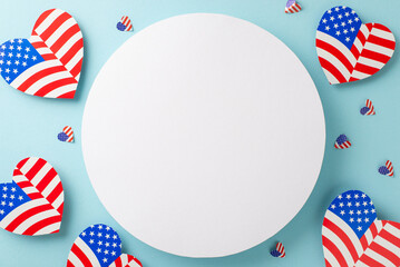 Obraz premium Congratulations on USA's Independence Day! A top view of symbolic adornments, hearts featuring the American flag pattern on a pastel blue background with large vacant circle for text or advertising