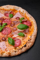 Delicious fresh oven baked pizza with salami, meat, cheese, tomatoes