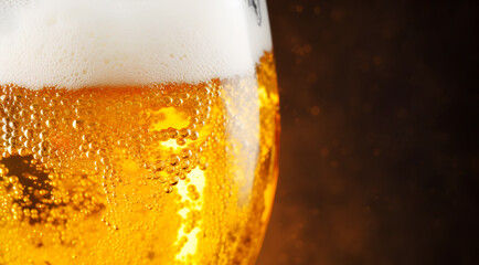Glass of beer close up, on dark background. Banner with space for text