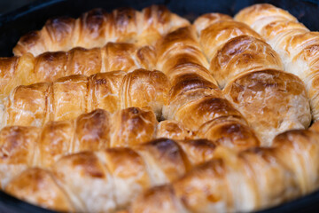Top view on baked puff pastry, homemade rolls as a snack for breakfast. Selective focus