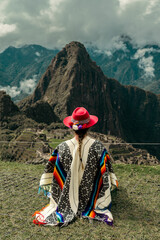 Tourist photography in Machu Picchu. Traveler with poncho and Inca hat. Wonder of the World. Colors	