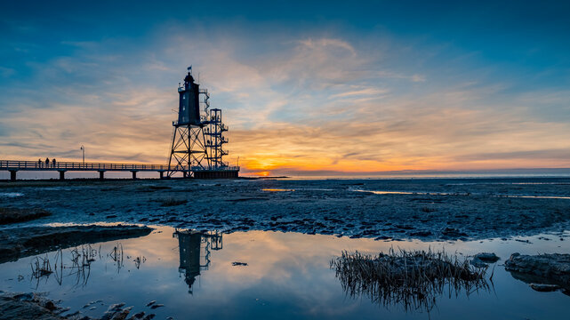 Obereversand lighthouse at sunset. Silhouette of the historic lighthouse Obereversand in Am Kutterhafen, Dorum-Neufeld, Wurster Nordseekuste, Germany. 