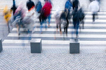 Blurred people walking on the crosswalk
