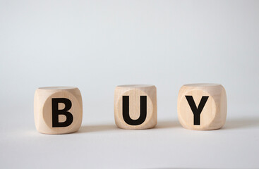 BUY symbol. Concept word BUY on wooden blocks. Beautiful white background. Business and BUY concept. Copy space
