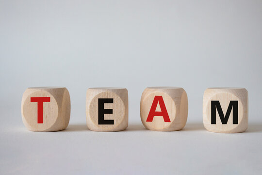 Team symbol. Concept word Team on wooden cubes. Beautiful white background. Business and Team concept. Copy space.