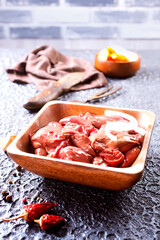 Raw liver with onion in wooden bowl