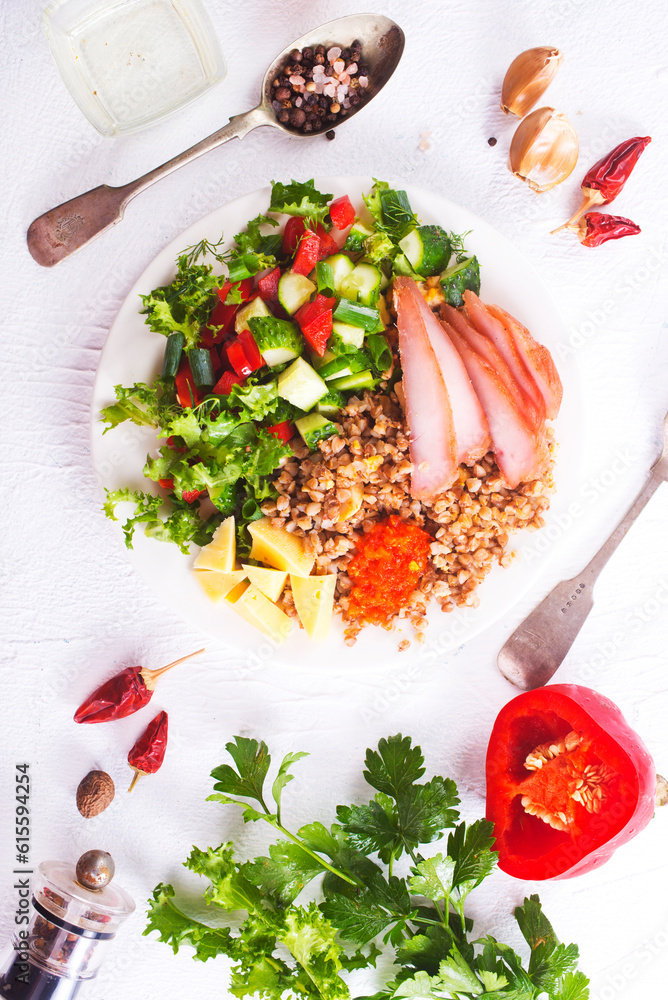 Sticker a plate of buckwheat with meat, salad , cheese on white backgrond