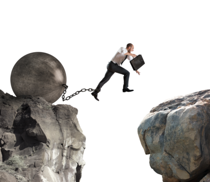 businessman tries to jump attached to a big ball