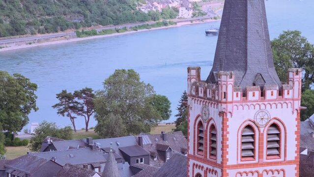top view of medieval German city of Bacharach, Postenturm, barges sail on wide Rhine River, valley among luxurious vineyards, wine tourism in Rhineland-Palatinate, Points of Interest and Landmarks