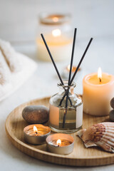Cozy corner for home meditation and relaxation. Aroma diffuser, burning candles, stones for...