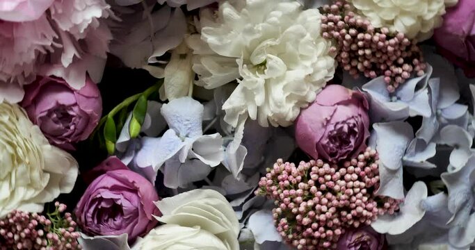 Rotating spring summer floral pastel arrangement in the background close up. Celebrating Mother's Day, International Women's Day March 8. Flowers gardenia, rose, peony
