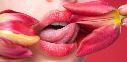 Plump sensual lips. lips with tulip flower. Sensual woman mouth, macro lip. Close up sensual lips...