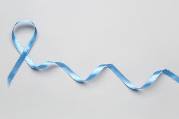 Blue satin ribbon on light background. Prostate cancer concept