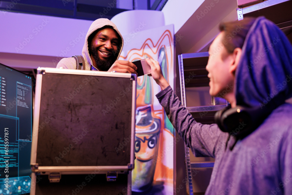 Poster smiling hacker bringing ssd with computer virus in abandoned warehouse. african american malware dev