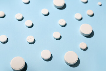 White pills on blue background