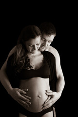 Father and pregnant mother in underwear holding naked round belly. Last month of pregnancy - 36th...
