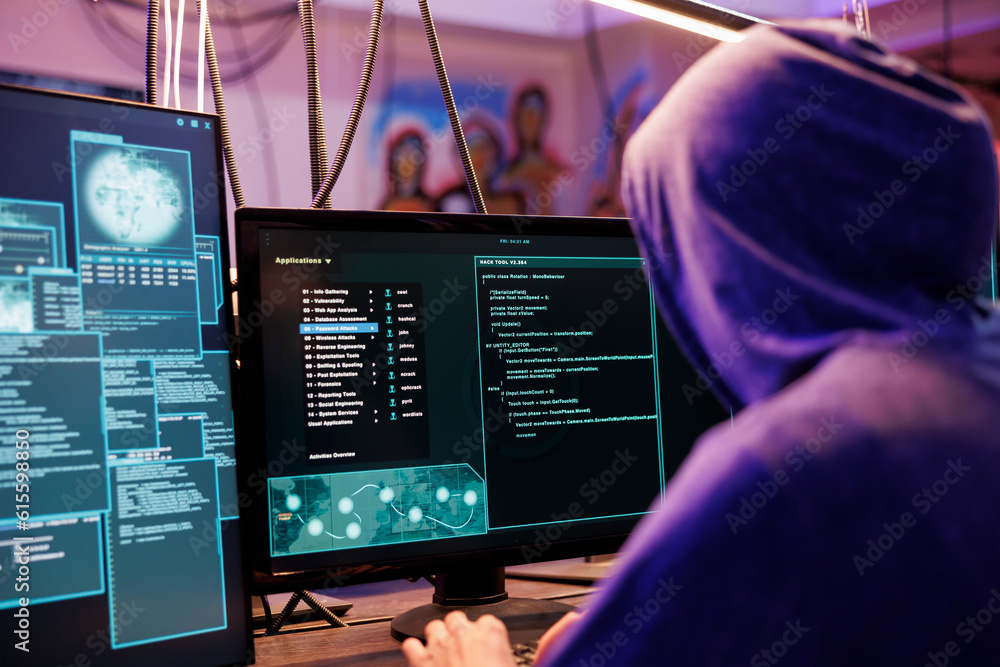 Poster hacker in hood running illegal malware on computer screen with multiple windows. criminal launching 