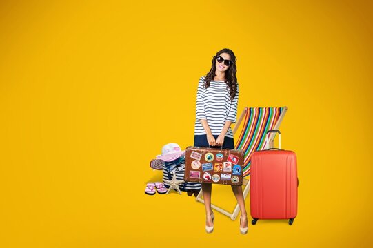 Young happy woman with baggage ready to travel