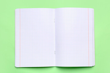 Blank copybook pages on green background