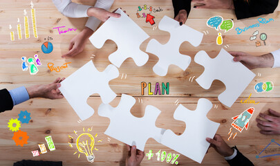 Business people join puzzle pieces in office. Concept of teamwork and partnership