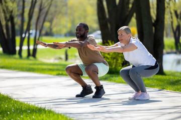 Couple exercising in the park and doing squats