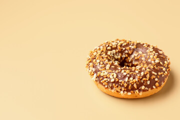 Sweet chocolate donut on beige background
