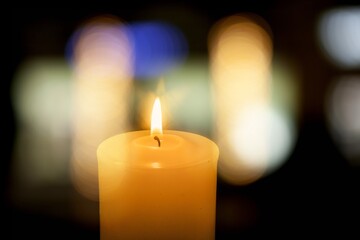 Beautiful aroma candle with fire on the desk