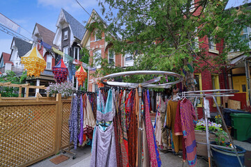 Colorful dresses for sale in the Kensington Market area where old houses have been converted to stores - 615603618
