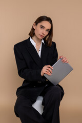 Young cute business woman with tablet in hands