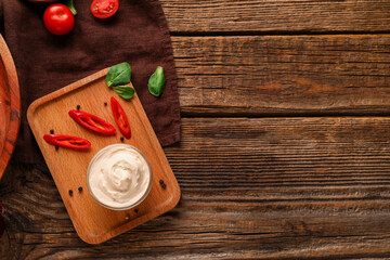Bowl of tasty cream cheese on wooden background