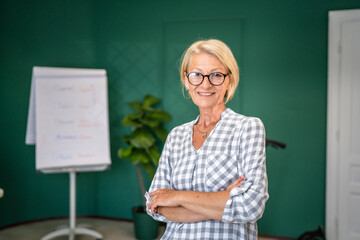 Portrait of one mature blonde caucasian woman with eyeglasses indoor